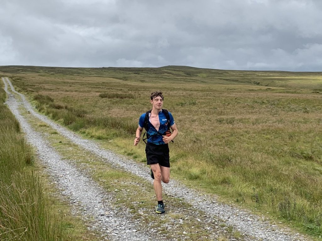 Eddie running along a track in the countryside